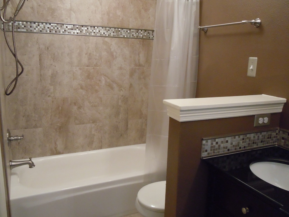 Medium sized classic family bathroom in Houston with a submerged sink, freestanding cabinets, dark wood cabinets, solid surface worktops, an alcove bath, a shower/bath combination, a two-piece toilet, beige tiles, porcelain tiles, brown walls and porcelain flooring.