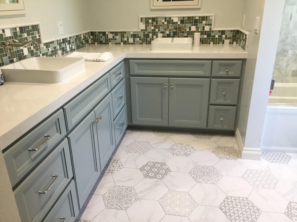 Design ideas for a medium sized traditional ensuite bathroom in Orange County with shaker cabinets, green cabinets, an alcove bath, a shower/bath combination, a one-piece toilet, grey tiles, stone tiles, green walls, porcelain flooring, a vessel sink and engineered stone worktops.