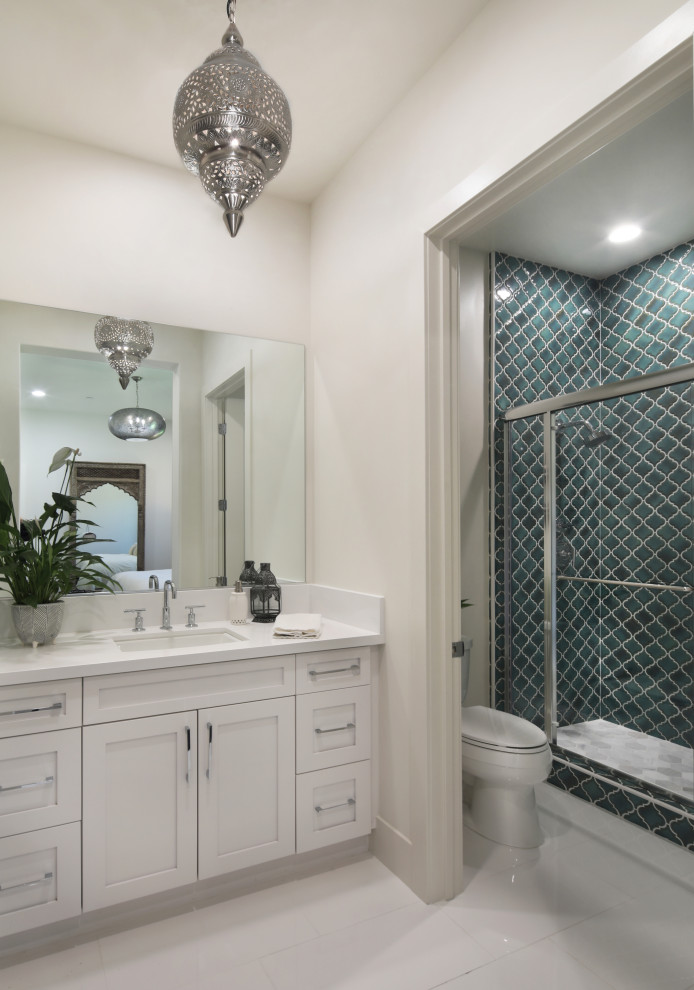 Mid-sized tuscan kids' blue tile and ceramic tile marble floor and white floor bathroom photo in Orange County with shaker cabinets, white cabinets, a one-piece toilet, white walls, a drop-in sink, granite countertops and white countertops