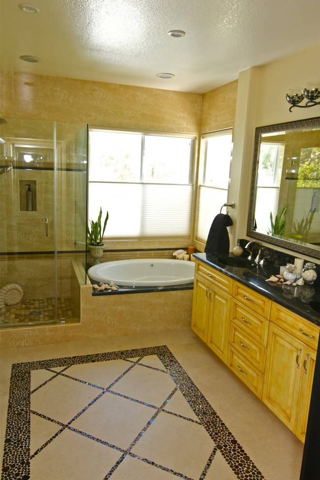 Photo of a large nautical ensuite bathroom in Orange County with a hot tub, a corner shower, beige walls, shaker cabinets and light wood cabinets.