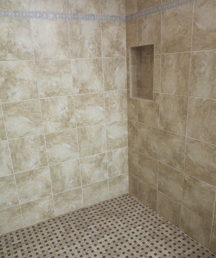 Photo of a small classic ensuite bathroom in Orange County with an alcove shower, a two-piece toilet, beige tiles, porcelain tiles, beige walls and mosaic tile flooring.