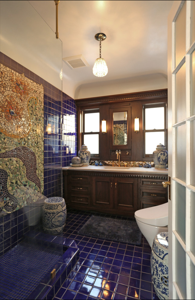 Inspiration for a small eclectic master blue tile and ceramic tile ceramic tile and blue floor bathroom remodel in Portland with furniture-like cabinets, dark wood cabinets, a wall-mount toilet, blue walls, an undermount sink and quartzite countertops