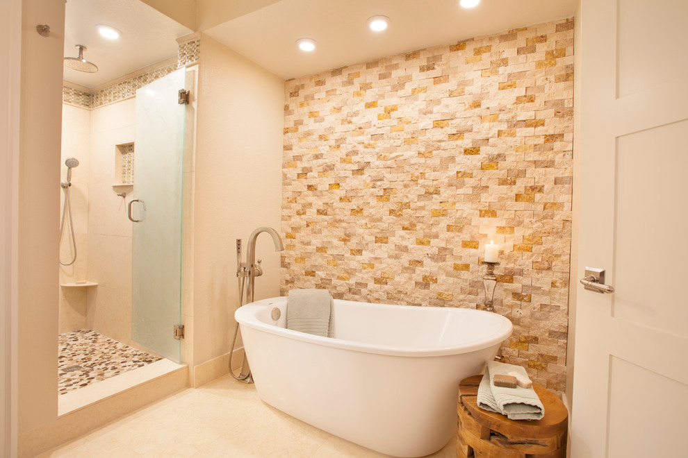 Example of a mid-sized island style master multicolored tile and mosaic tile travertine floor and beige floor bathroom design in Miami with flat-panel cabinets, medium tone wood cabinets, a two-piece toilet, beige walls, marble countertops and a hinged shower door