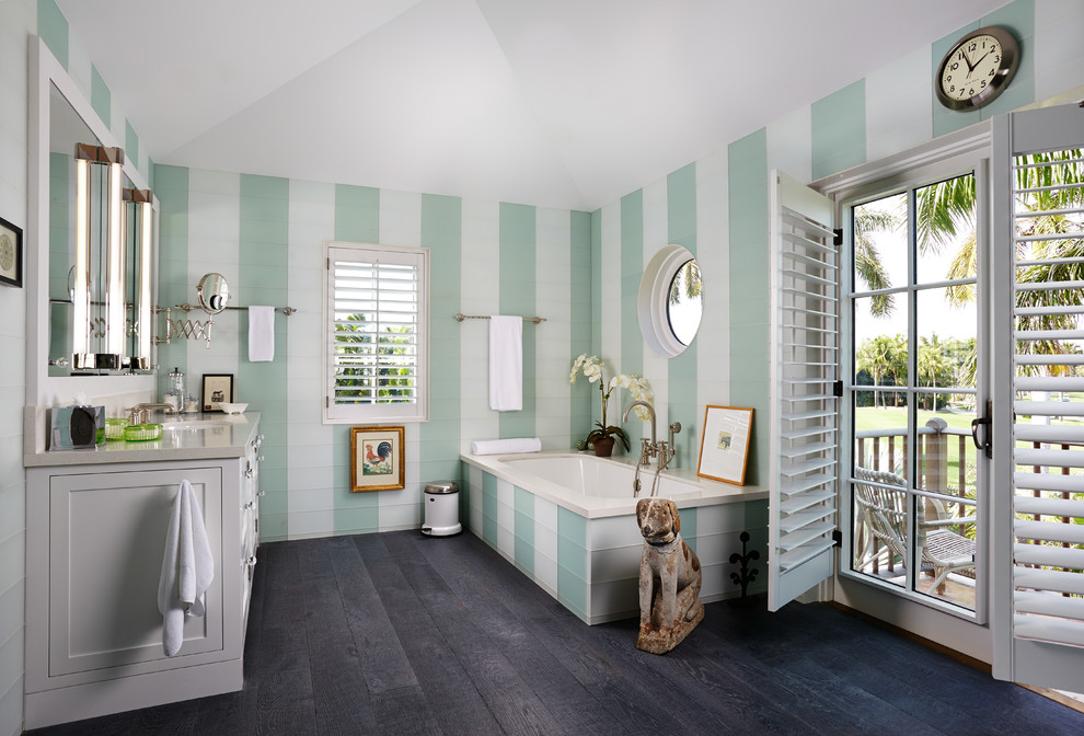 Идея дизайна: главная ванная комната среднего размера в морском стиле с белыми фасадами, полновстраиваемой ванной, зелеными стенами, темным паркетным полом, накладной раковиной и столешницей из гранита