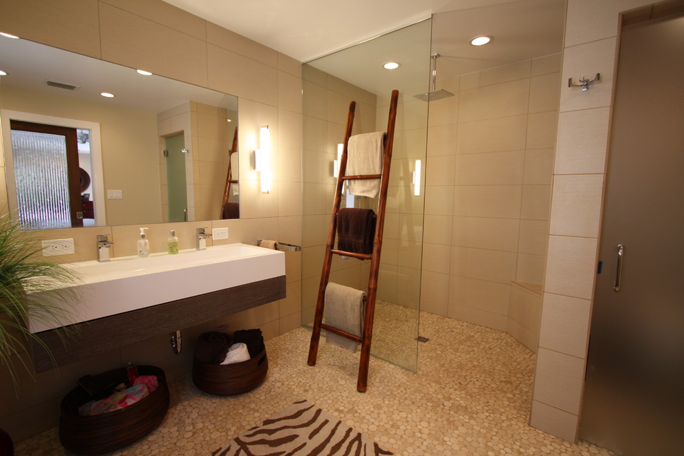 Пример оригинального дизайна: главная ванная комната среднего размера в восточном стиле с открытыми фасадами, темными деревянными фасадами, открытым душем, бежевой плиткой, керамогранитной плиткой, бежевыми стенами, полом из галечной плитки, подвесной раковиной, бежевым полом и открытым душем
