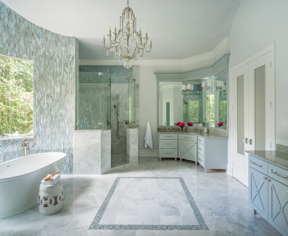 Large classic ensuite bathroom in Houston with shaker cabinets, grey cabinets, a freestanding bath, a corner shower, grey walls, marble flooring, a submerged sink, quartz worktops, white floors, a hinged door and grey worktops.