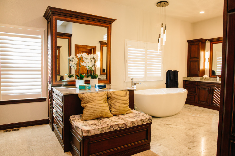 Example of a huge classic master white tile and marble tile marble floor and white floor bathroom design in Denver with raised-panel cabinets, medium tone wood cabinets, a one-piece toilet, white walls, an undermount sink, marble countertops and a hinged shower door