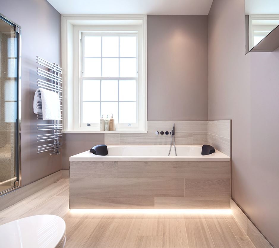Modern inredning av ett mellanstort badrum, med ett fristående handfat, möbel-liknande, ett platsbyggt badkar, en dusch i en alkov, en vägghängd toalettstol, beige kakel, porslinskakel, beige väggar och klinkergolv i porslin