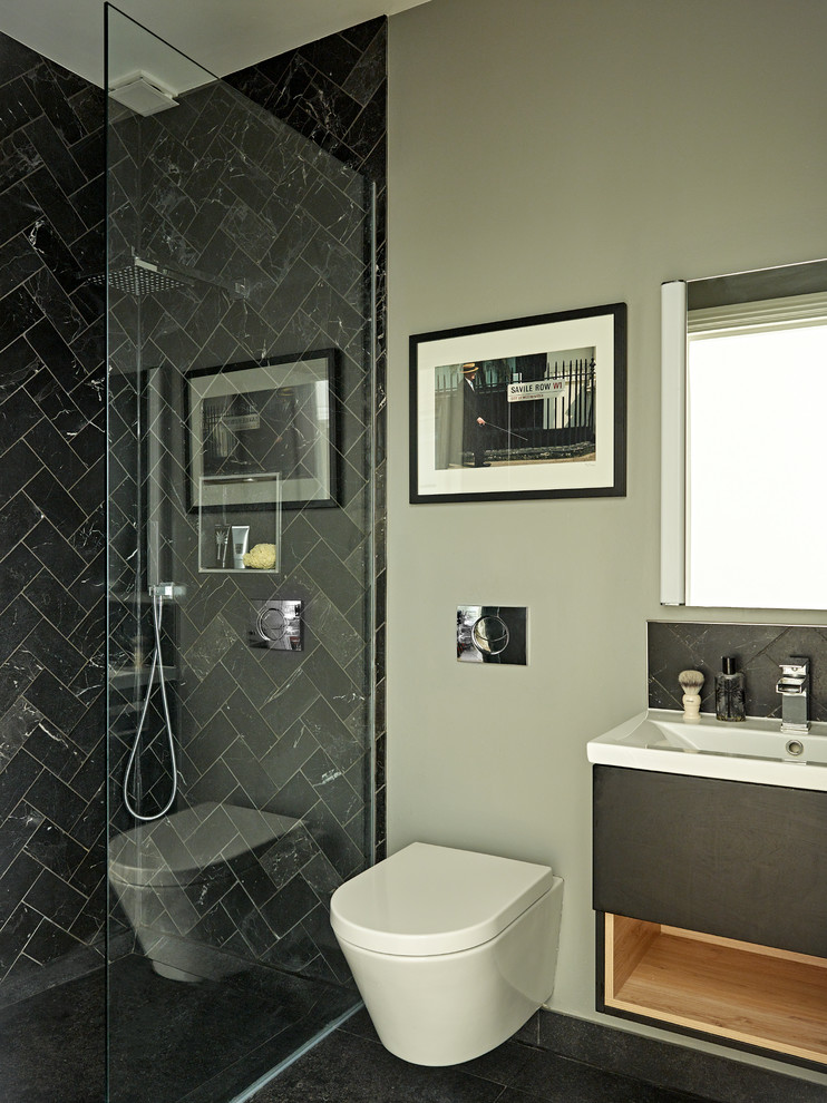 Idées déco pour une salle de bain éclectique avec des portes de placard noires, un espace douche bain, WC suspendus, du carrelage en marbre, un mur gris, un sol en carrelage de céramique, un lavabo suspendu, un plan de toilette en surface solide, un sol noir et un plan de toilette blanc.