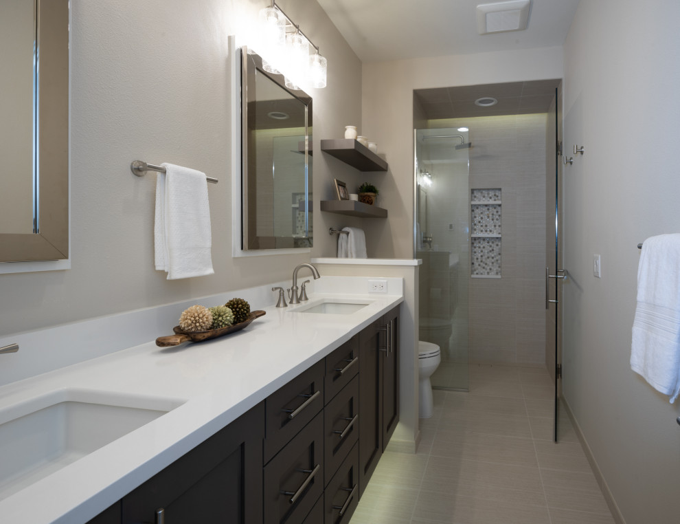 Mid-sized transitional master beige tile and porcelain tile porcelain tile and beige floor walk-in shower photo in Seattle with shaker cabinets, brown cabinets, a two-piece toilet, beige walls, an undermount sink, quartz countertops, a hinged shower door and white countertops