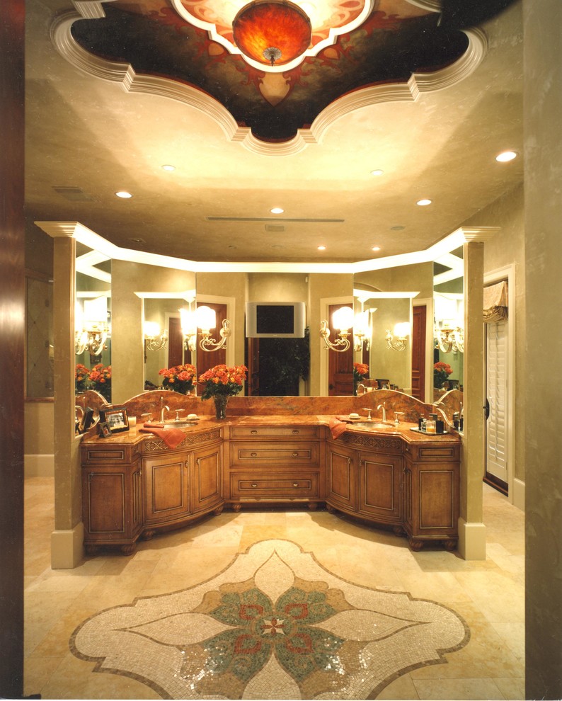 На фото: большая главная ванная комната в средиземноморском стиле с фасадами с выступающей филенкой, искусственно-состаренными фасадами, бежевой плиткой, плиткой мозаикой, полом из травертина, врезной раковиной и мраморной столешницей