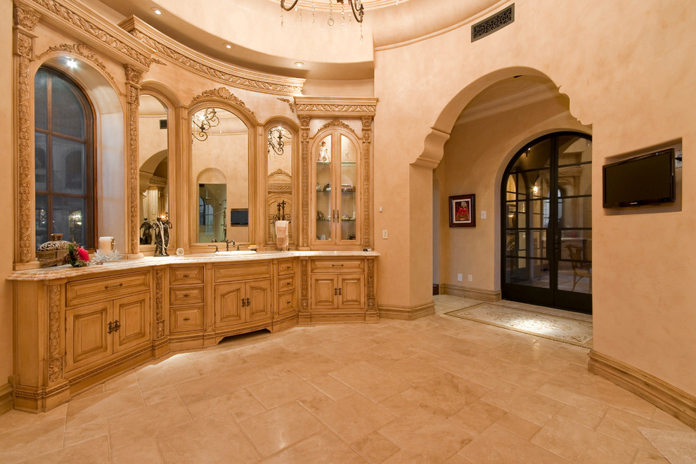 Inspiration for a huge mediterranean master multicolored tile and mirror tile travertine floor and multicolored floor bathroom remodel in Phoenix with furniture-like cabinets, brown cabinets, a one-piece toilet, multicolored walls, a vessel sink, granite countertops and multicolored countertops