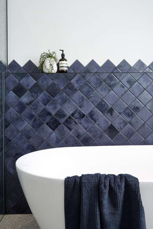 Navy Elegance: Navy-Blue Diamond Tiles with a White Freestanding Bathtub