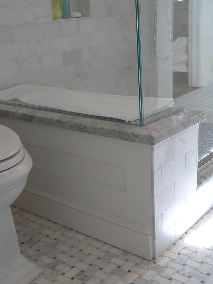 Photo of a medium sized traditional family bathroom in New York with a submerged sink, recessed-panel cabinets, white cabinets, granite worktops, a walk-in shower, a two-piece toilet, grey tiles, stone tiles, white walls and mosaic tile flooring.