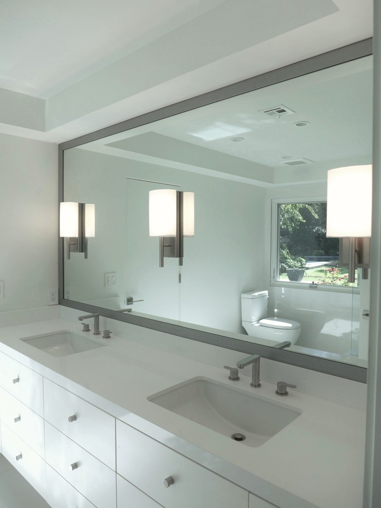 Mid-sized minimalist master bathroom photo in Other with flat-panel cabinets, white cabinets, a two-piece toilet, white walls, an undermount sink and quartz countertops