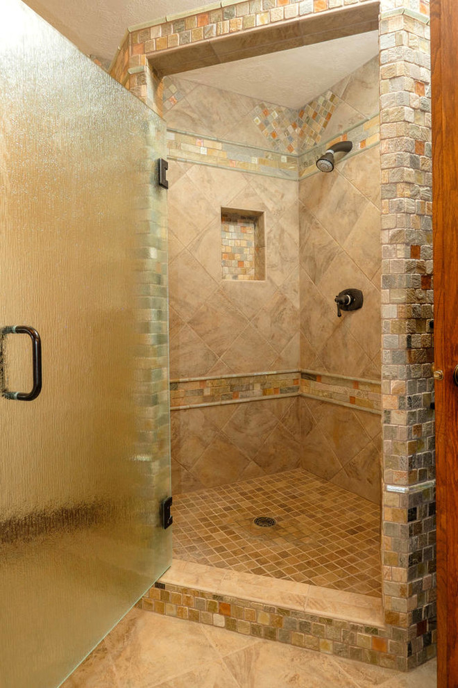 Inspiration for a medium sized rustic ensuite bathroom in Minneapolis with a submerged sink, raised-panel cabinets, medium wood cabinets, granite worktops, a built-in bath, a corner shower, a one-piece toilet, multi-coloured tiles, stone tiles, beige walls and porcelain flooring.