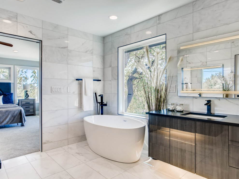 Large trendy master white tile white floor and double-sink bathroom photo in Denver with a one-piece toilet, white walls, an undermount sink, a hinged shower door, black countertops and a floating vanity