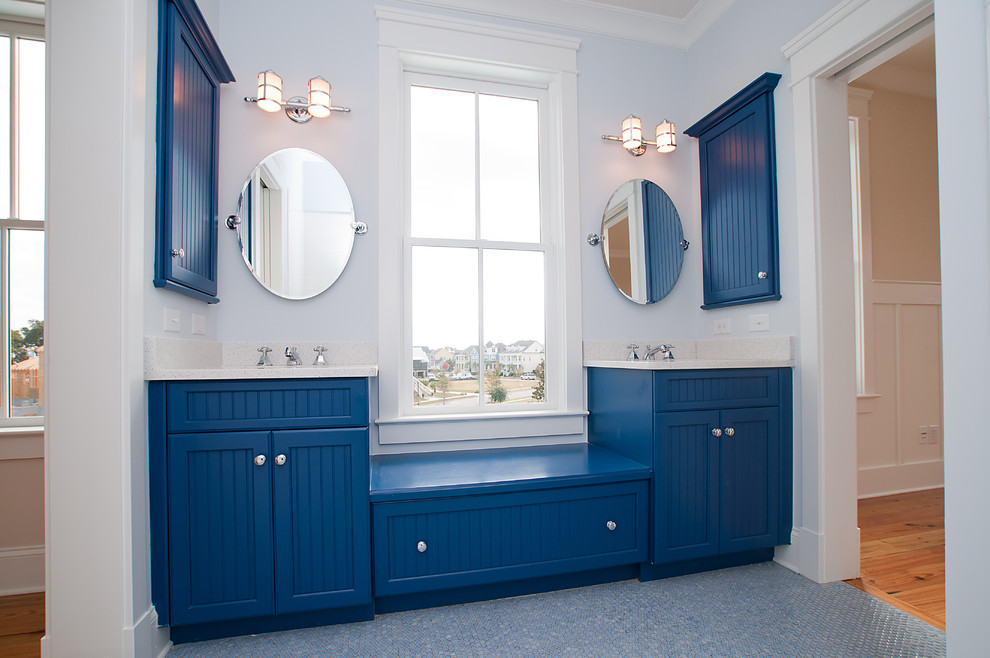 Bathroom - eclectic blue tile and mosaic tile bathroom idea in Charleston with recessed-panel cabinets and blue cabinets
