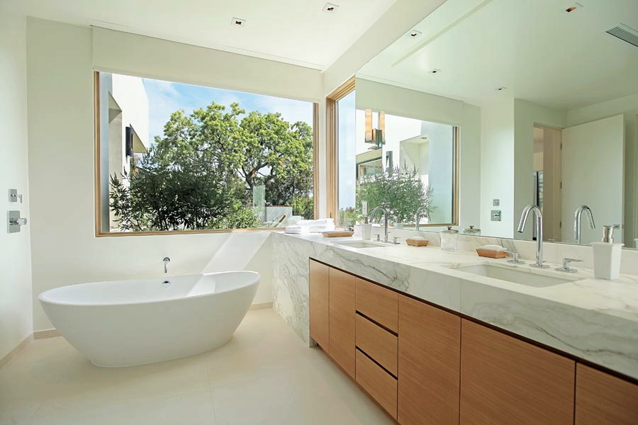 Inspiration for a large retro ensuite bathroom in Los Angeles with a submerged sink, flat-panel cabinets, medium wood cabinets, marble worktops, a freestanding bath, a corner shower, a one-piece toilet, beige tiles, porcelain tiles, white walls and ceramic flooring.