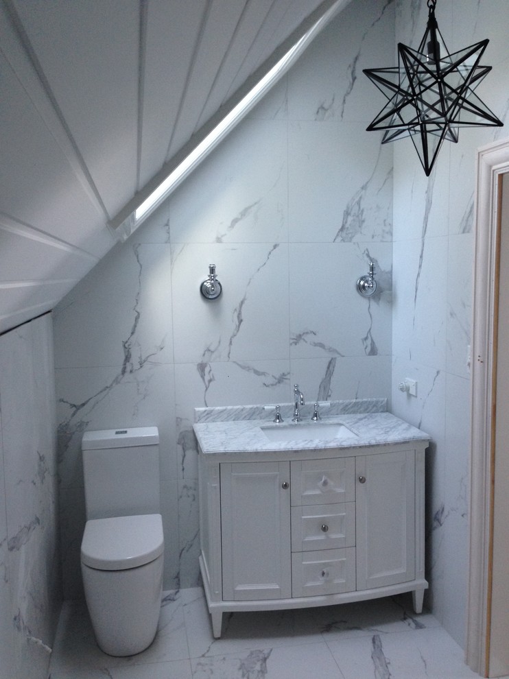 This is an example of a medium sized nautical ensuite bathroom in Sydney with freestanding cabinets, grey cabinets, a freestanding bath, a two-piece toilet, multi-coloured tiles, ceramic tiles, ceramic flooring, a submerged sink, marble worktops and multi-coloured floors.