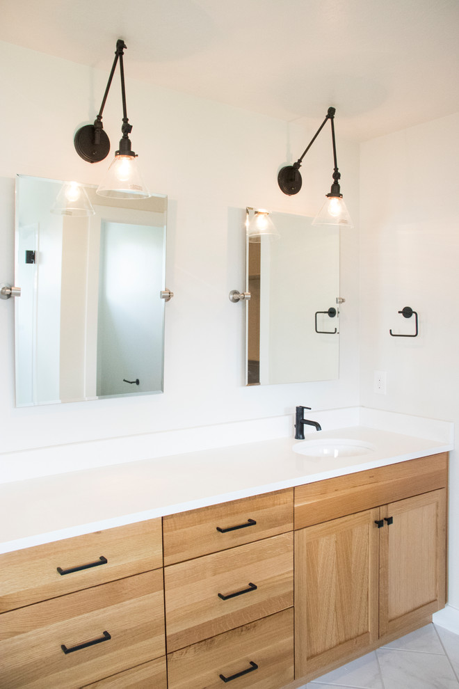 Mid-sized cottage kids' ceramic tile and white floor doorless shower photo in Salt Lake City with shaker cabinets, light wood cabinets, white walls, an undermount sink, quartz countertops, a hinged shower door and white countertops