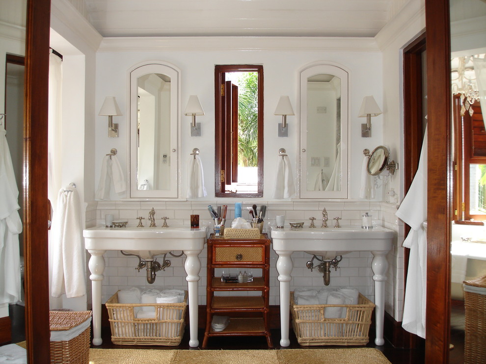 Example of an island style white tile and subway tile bathroom design in New York with a console sink