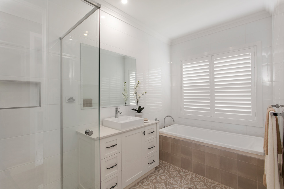 Bathroom - mid-sized country master white tile and ceramic tile porcelain tile and beige floor bathroom idea in Wollongong with shaker cabinets, white cabinets, a vessel sink, quartz countertops, a hinged shower door and white countertops