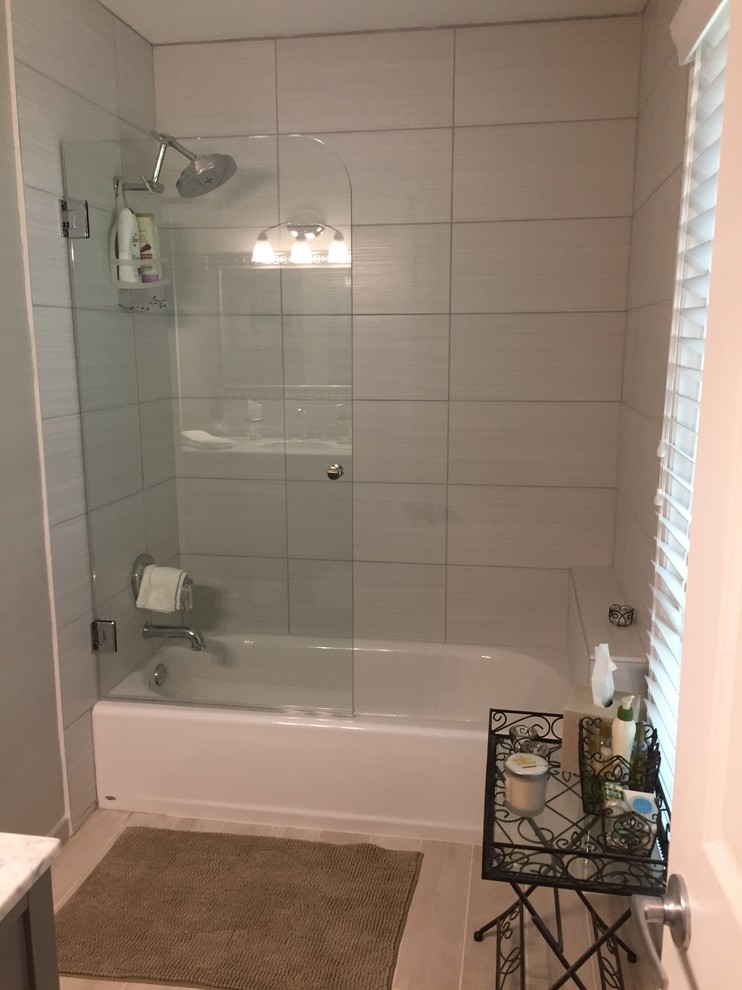 На фото: ванная комната среднего размера в стиле модернизм с накладной ванной, угловым душем, унитазом-моноблоком, серой плиткой, мраморной плиткой, серыми стенами, мраморным полом, мраморной столешницей и серым полом с