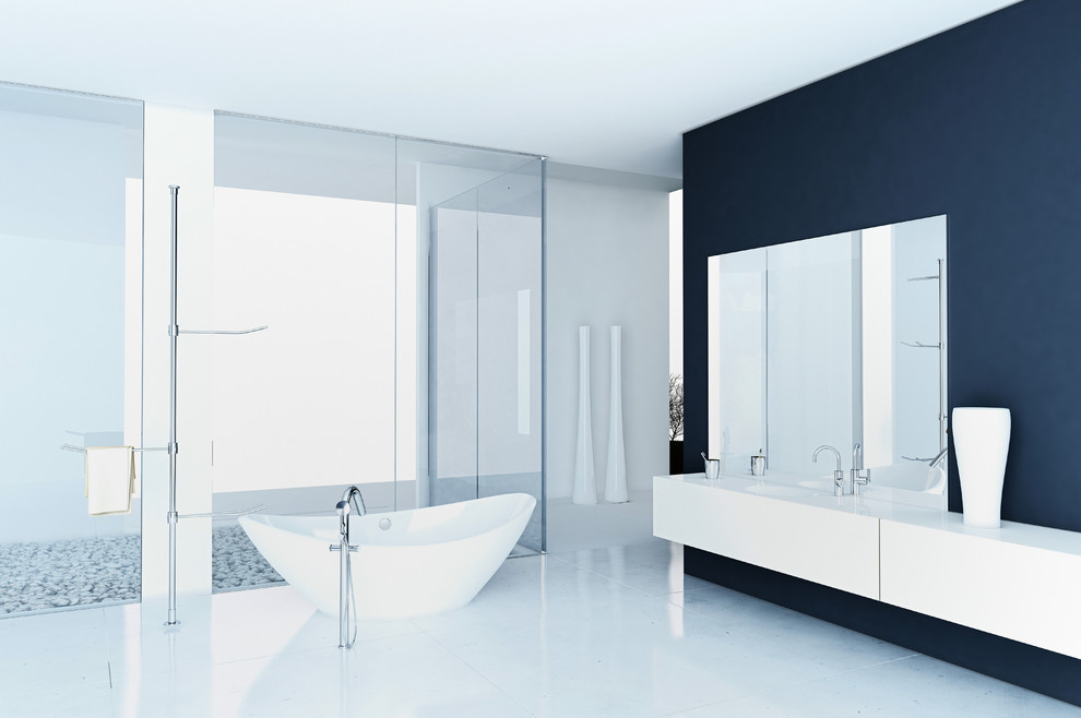Идея дизайна: огромная главная ванная комната в стиле модернизм с плоскими фасадами, белыми фасадами, отдельно стоящей ванной, душевой комнатой, инсталляцией, керамической плиткой, серыми стенами, полом из керамической плитки, монолитной раковиной, столешницей из искусственного камня, серой плиткой, белым полом, открытым душем и белой столешницей