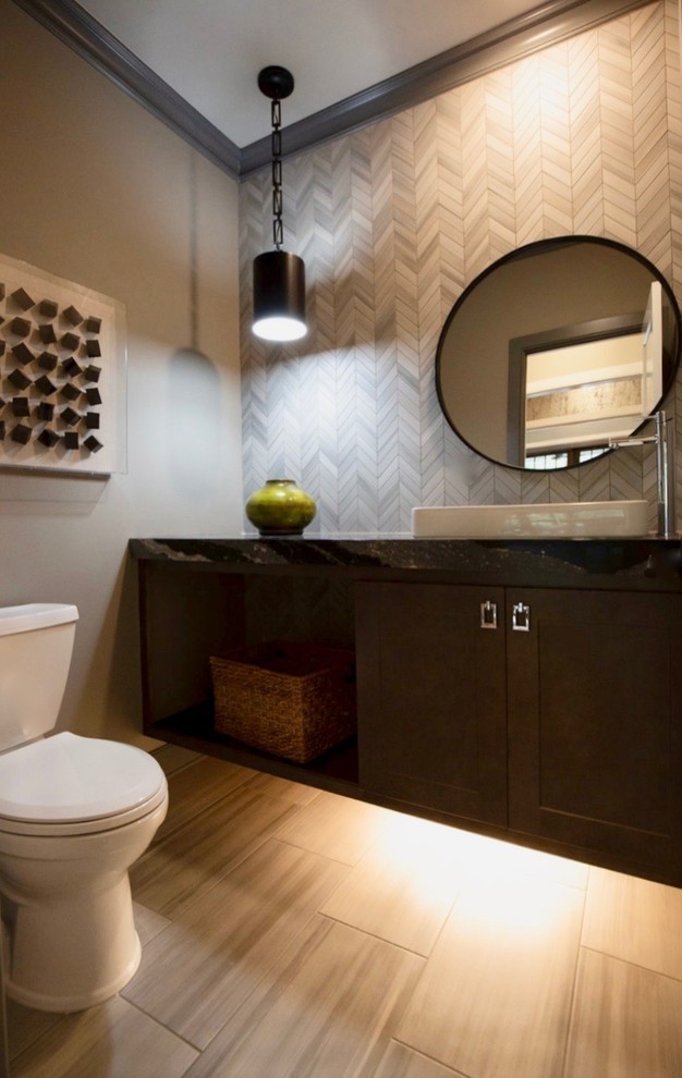 This is an example of a medium sized eclectic bathroom in New York with shaker cabinets, brown cabinets, a two-piece toilet, beige tiles, ceramic tiles, brown walls, cement flooring, a vessel sink, engineered stone worktops, beige floors and black worktops.