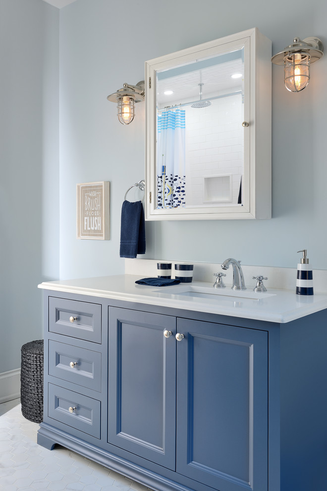 Immagine di una stanza da bagno per bambini tradizionale con ante blu, pareti blu, pavimento bianco, top bianco, ante con riquadro incassato e lavabo sottopiano