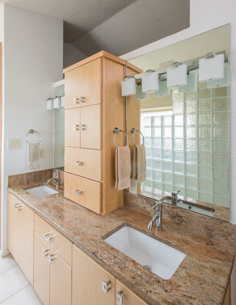 Inspiration for a mid-sized asian master beige tile and porcelain tile porcelain tile bathroom remodel in Austin with an undermount sink, flat-panel cabinets, light wood cabinets, granite countertops and white walls