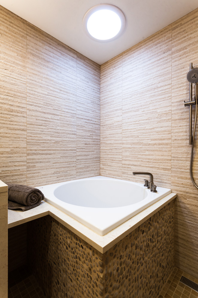 Large world-inspired ensuite bathroom in Newark with a submerged sink, flat-panel cabinets, medium wood cabinets, marble worktops, a japanese bath, a walk-in shower, a wall mounted toilet, beige tiles, ceramic tiles, beige walls and ceramic flooring.