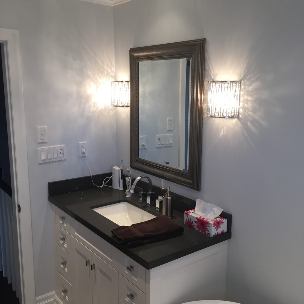 Example of a mid-sized trendy 3/4 gray tile and ceramic tile ceramic tile and gray floor bathroom design in Toronto with shaker cabinets, white cabinets, a two-piece toilet, gray walls, an undermount sink, granite countertops and a hinged shower door