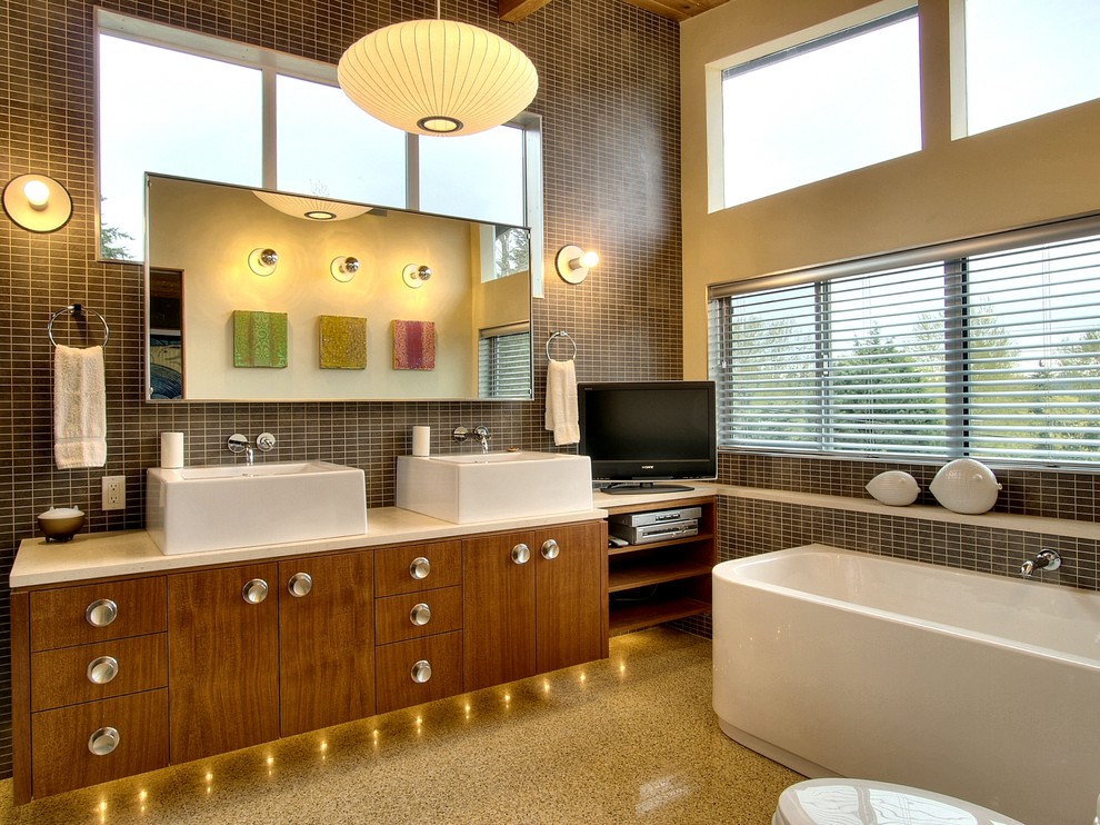 Photo of a retro bathroom in Seattle with a vessel sink, flat-panel cabinets, dark wood cabinets, a freestanding bath and black tiles.