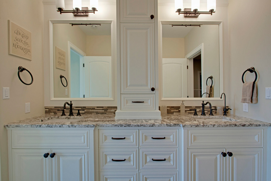 This is an example of a medium sized rustic family bathroom in Calgary with a submerged sink, raised-panel cabinets, white cabinets, granite worktops, beige tiles, stone tiles, beige walls and ceramic flooring.