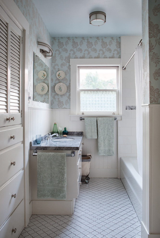 Alcove bathtub - mid-sized traditional 3/4 white tile and ceramic tile ceramic tile and gray floor alcove bathtub idea in San Francisco with flat-panel cabinets, white cabinets, a one-piece toilet, multicolored walls, an undermount sink, marble countertops and black countertops
