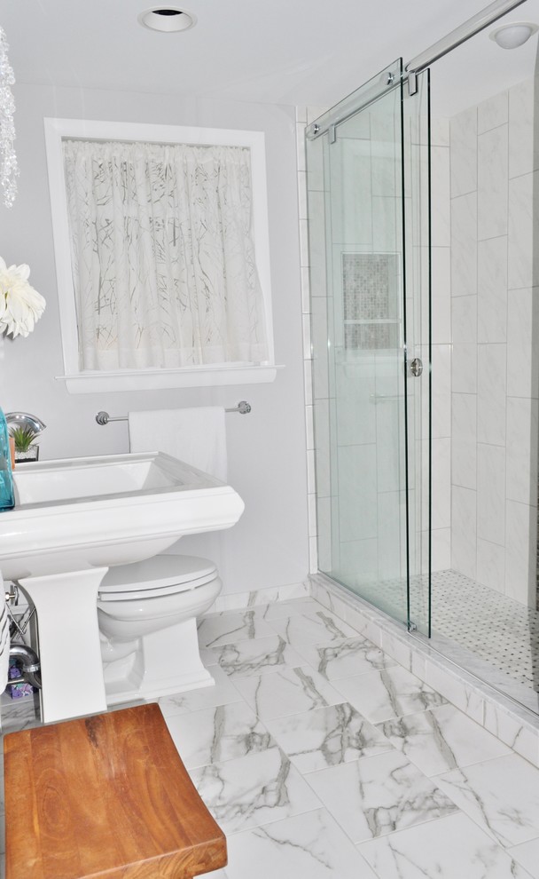 This is an example of a small traditional ensuite bathroom in Philadelphia with a pedestal sink, white cabinets, a walk-in shower, a two-piece toilet, white tiles, porcelain tiles, grey walls and porcelain flooring.