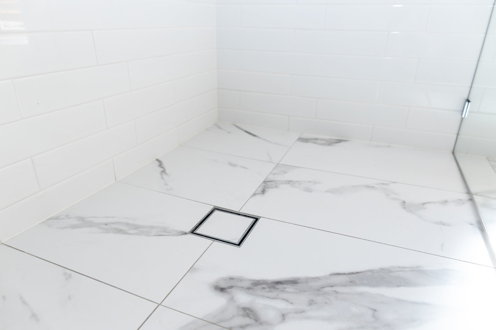 Design ideas for a medium sized contemporary ensuite wet room bathroom in Canberra - Queanbeyan with light wood cabinets, white tiles, metro tiles, white walls, porcelain flooring, a vessel sink, engineered stone worktops, white floors, an open shower and white worktops.