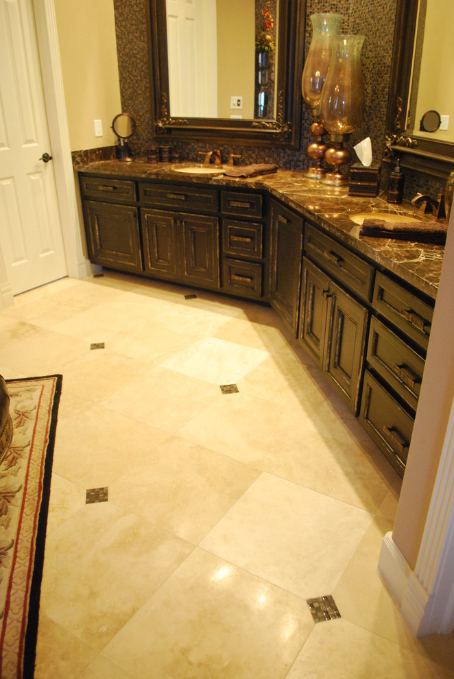 Large traditional ensuite bathroom in Houston with a submerged sink, flat-panel cabinets, dark wood cabinets, granite worktops, brown tiles, beige walls and travertine flooring.