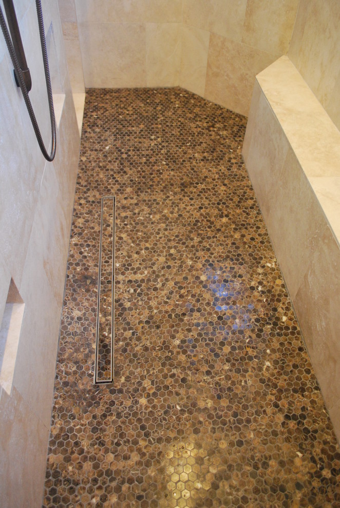 Doorless shower - large traditional master brown tile and stone tile mosaic tile floor doorless shower idea in Houston with beige walls