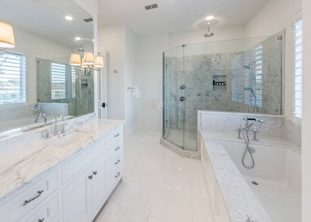 Corner shower - large contemporary white tile and porcelain tile porcelain tile corner shower idea in Dallas with an undermount sink, shaker cabinets, white cabinets, marble countertops, an undermount tub, a two-piece toilet and white walls