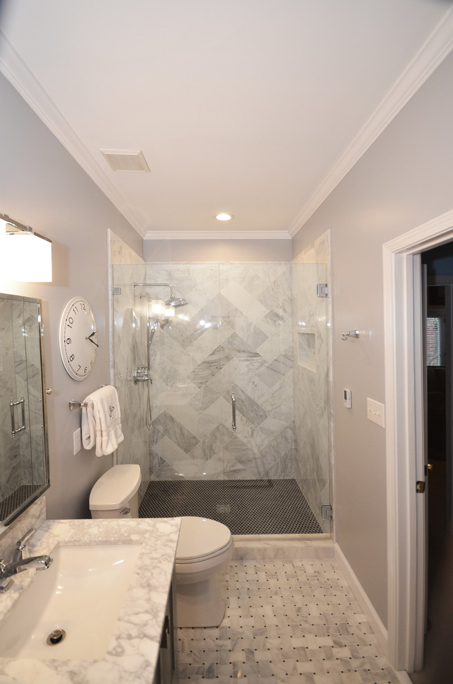 Mid-sized elegant master gray tile and stone slab marble floor alcove shower photo in Charlotte with shaker cabinets, gray cabinets, a two-piece toilet, blue walls, an undermount sink and marble countertops
