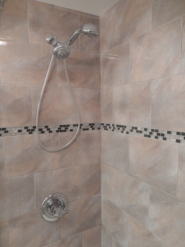 Small 3/4 brown tile and ceramic tile ceramic tile alcove shower photo in New York with an integrated sink, flat-panel cabinets, dark wood cabinets, quartz countertops, a two-piece toilet and brown walls