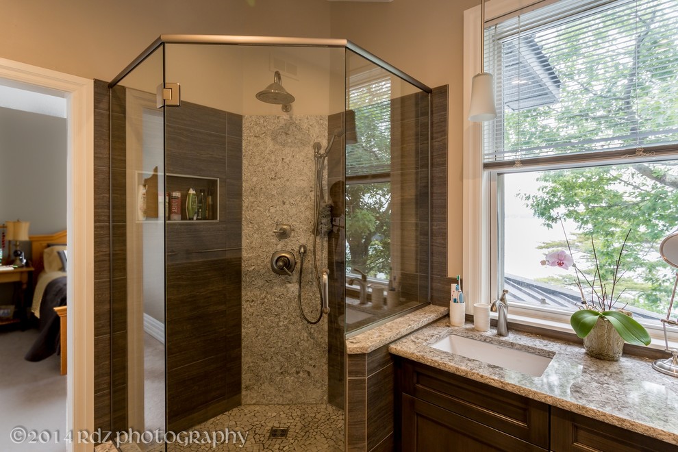 Photo of a medium sized classic ensuite bathroom in Toronto with a submerged sink, recessed-panel cabinets, grey cabinets, engineered stone worktops, a corner shower, a one-piece toilet, grey tiles, porcelain tiles, beige walls and slate flooring.