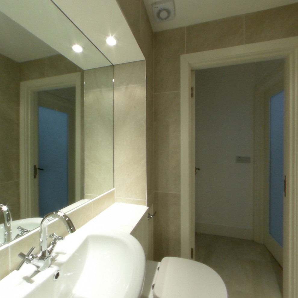 Medium sized country shower room bathroom in Dublin with an integrated sink, freestanding cabinets, light wood cabinets, tiled worktops, a double shower, a wall mounted toilet, brown tiles, porcelain tiles, brown walls and porcelain flooring.
