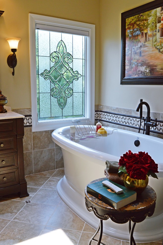 Inspiration for a large timeless master beige tile and porcelain tile porcelain tile bathroom remodel in Atlanta with furniture-like cabinets, dark wood cabinets, an undermount sink, granite countertops, a one-piece toilet and beige walls