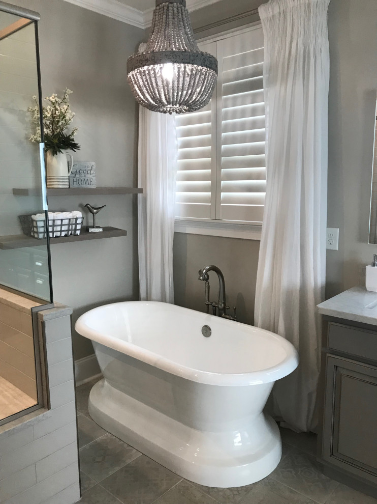 Design ideas for a small traditional ensuite bathroom in Other with raised-panel cabinets, grey cabinets, a freestanding bath, a corner shower, grey tiles, metro tiles, grey walls, porcelain flooring, a submerged sink, engineered stone worktops, grey floors, a hinged door and white worktops.