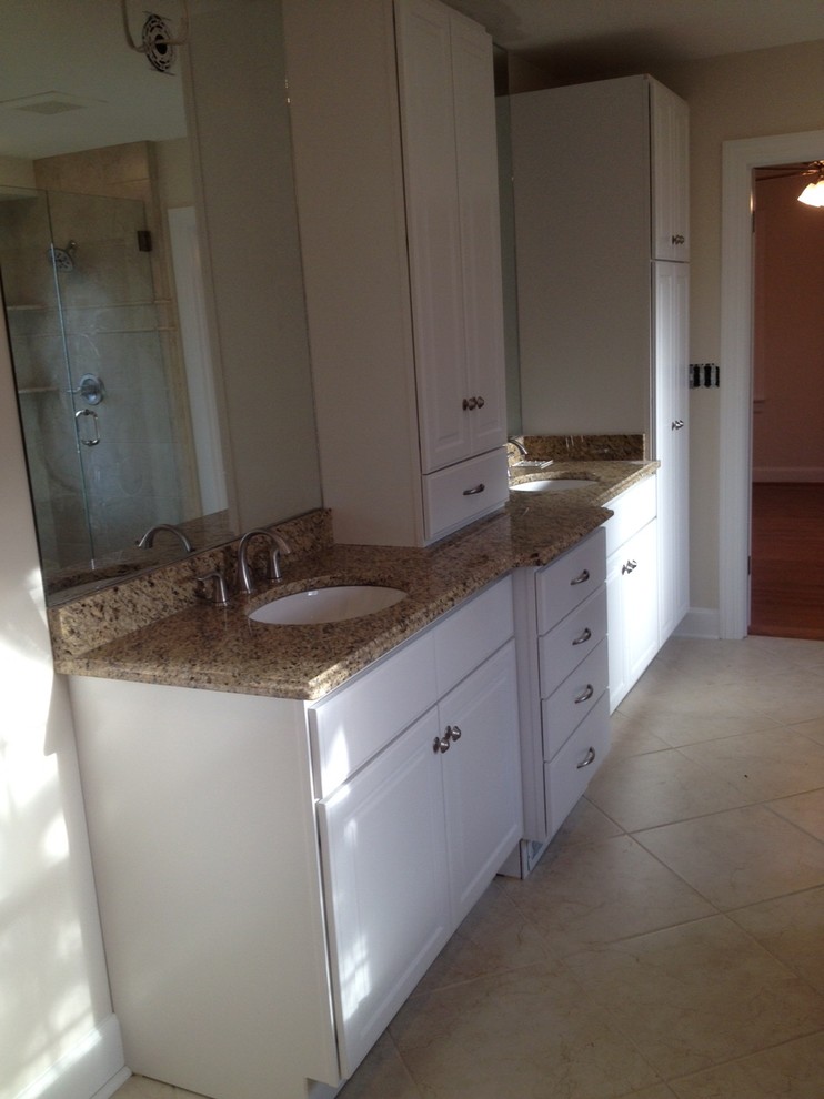 Bathroom photo in Louisville with an undermount sink, raised-panel cabinets, white cabinets and granite countertops