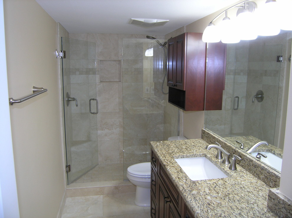 Design ideas for a medium sized classic shower room bathroom in Tampa with stone tiles, travertine flooring, granite worktops, raised-panel cabinets, dark wood cabinets, an alcove shower, beige tiles, beige walls, a submerged sink, beige floors and a hinged door.